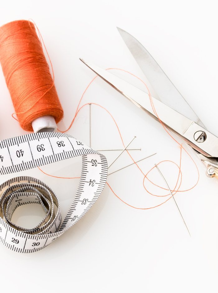 Cloth and sewing tools laid out on a work table