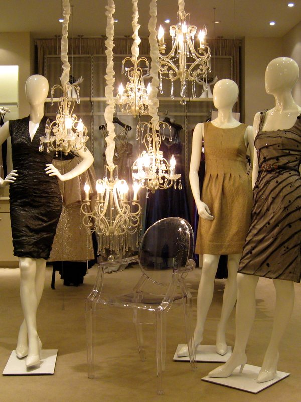 A row of dressed mannequins in a department store