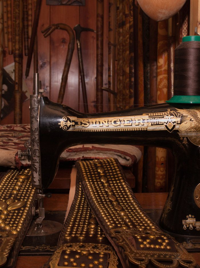 A workshop interior with cloth, patterns and a sewing machine