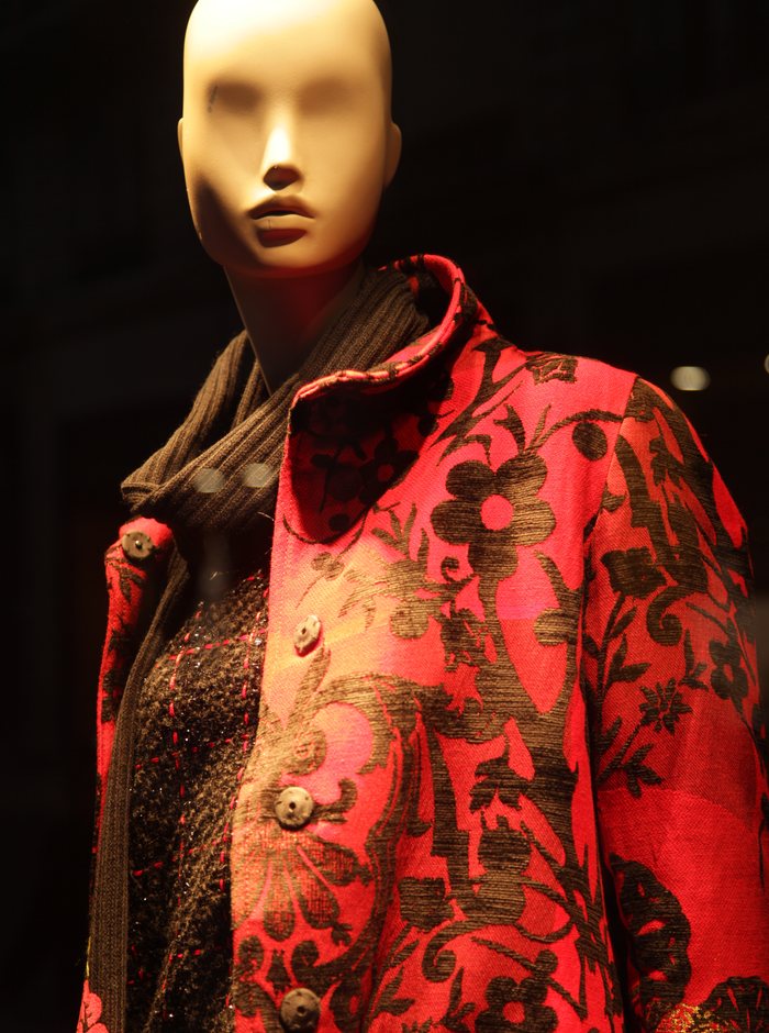 A garment being fitted and pinned on a mannequin
