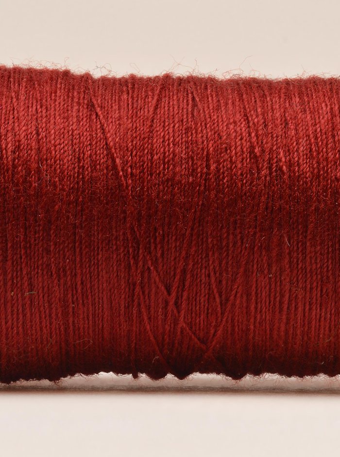 Red thread wound on a spool