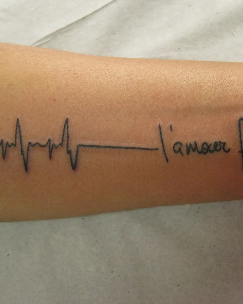 Vertical crop of a healed fine-line script and heartbeat piece