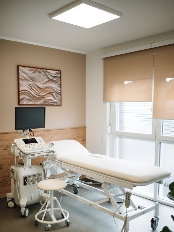 Treatment couch beside an ultrasound console