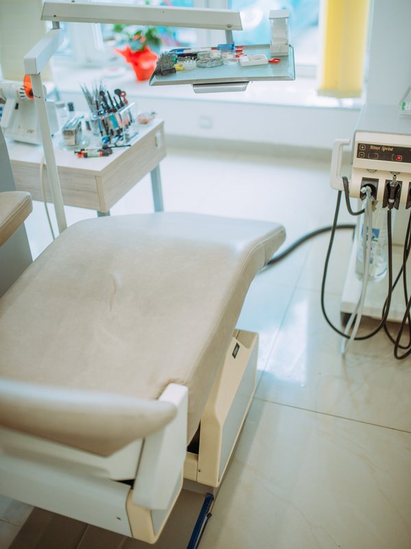 Treatment chair beside an instrument tray