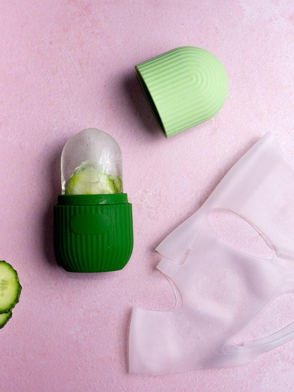Cucumber slices beside a cooling facial mask