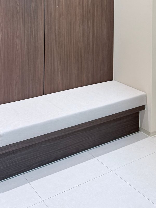 A padded bench against a walnut panel in the clinic waiting area