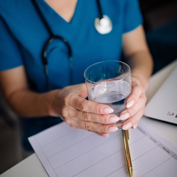 A clinician in scrubs at a consultation desk
