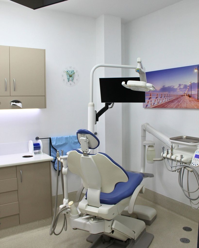 A treatment chair under the overhead light in one of our surgeries