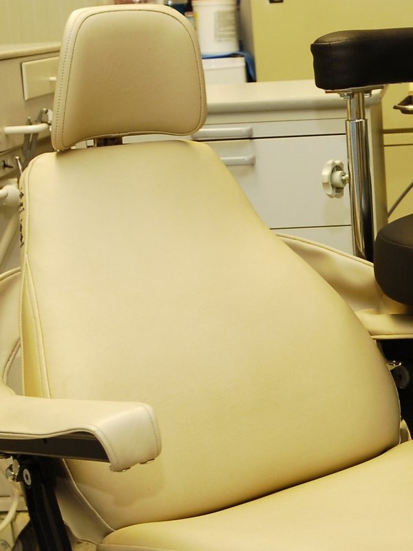 A treatment chair beside the chairside cabinetry