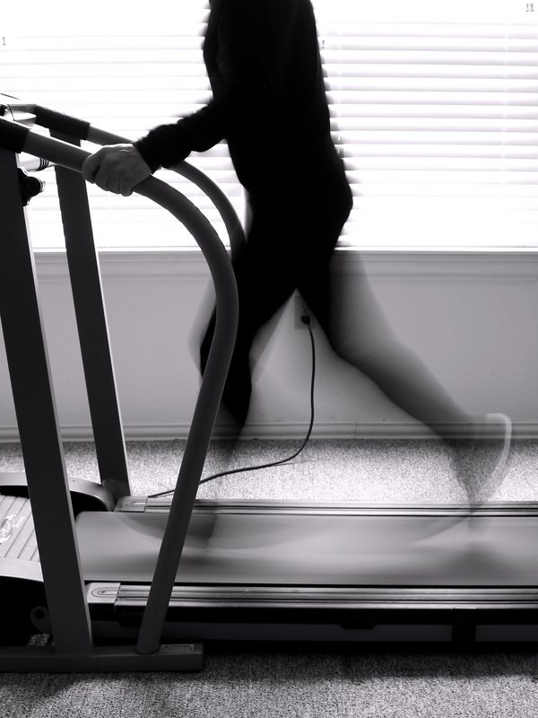 A treadmill in use, the runner blurred by motion