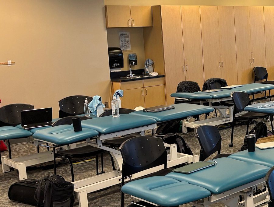 Rows of padded treatment tables in the clinic's therapy room