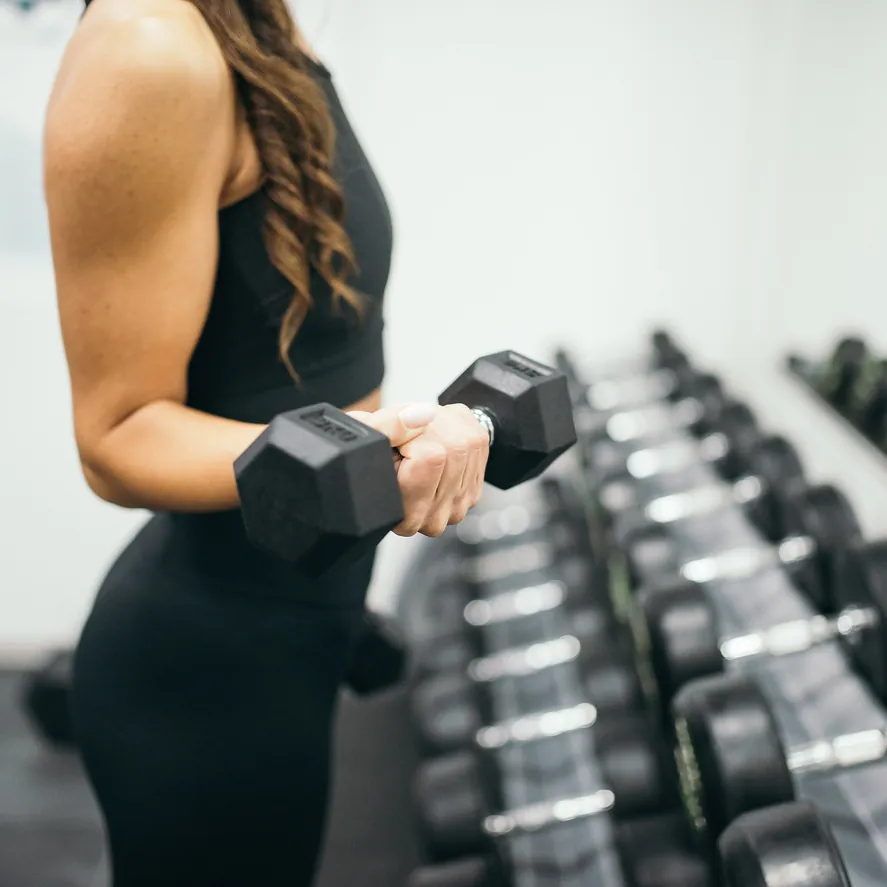 Close view of dumbbell positioning during a private coaching session