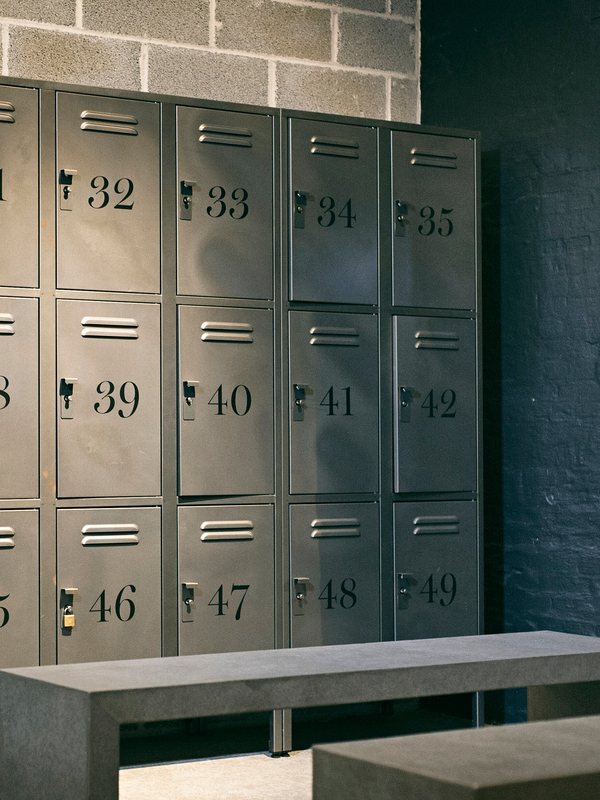 Numbered steel lockers and a bench in the Atlas changing room