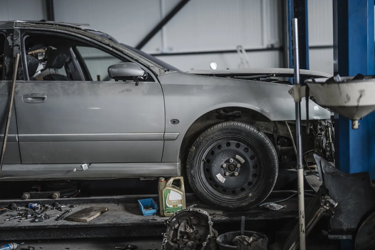 Car raised on a two-post lift during an under-body service
