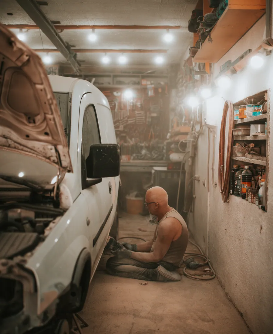 Close crop of a workshop bay with a van under repair