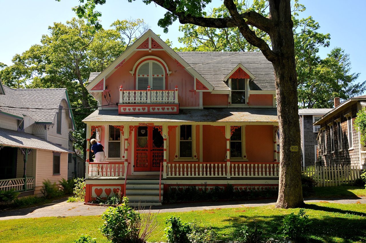 Dune Rose Retreat — rose-painted gingerbread cottage with a scalloped porch