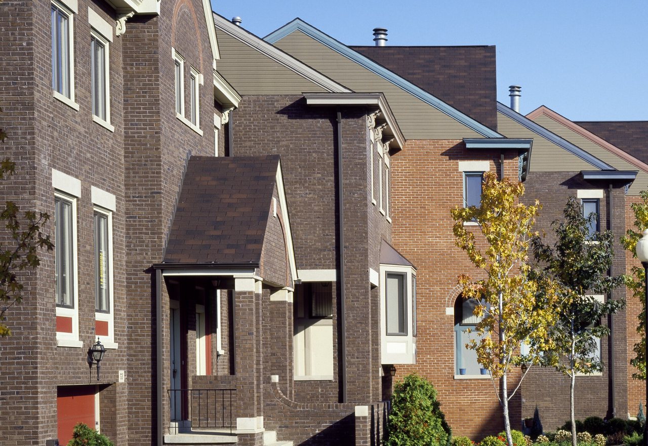 Fernvale Net-Zero Townhome — brick townhomes with steep gables along a newly landscaped street, Fernvale, OR
