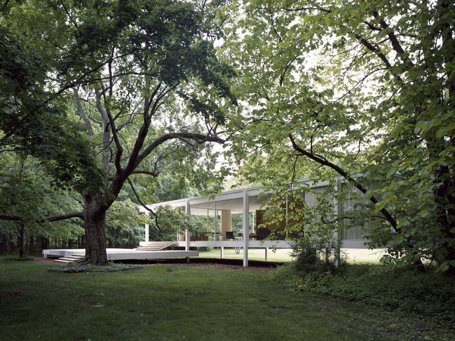 Glass-walled modernist pavilion among trees