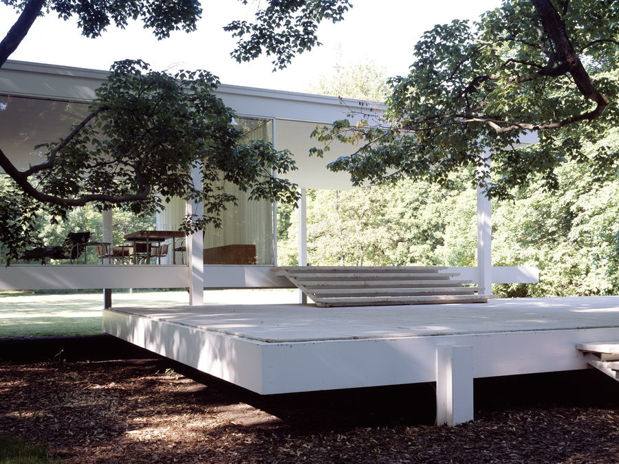White steel-framed glass pavilion raised above the ground