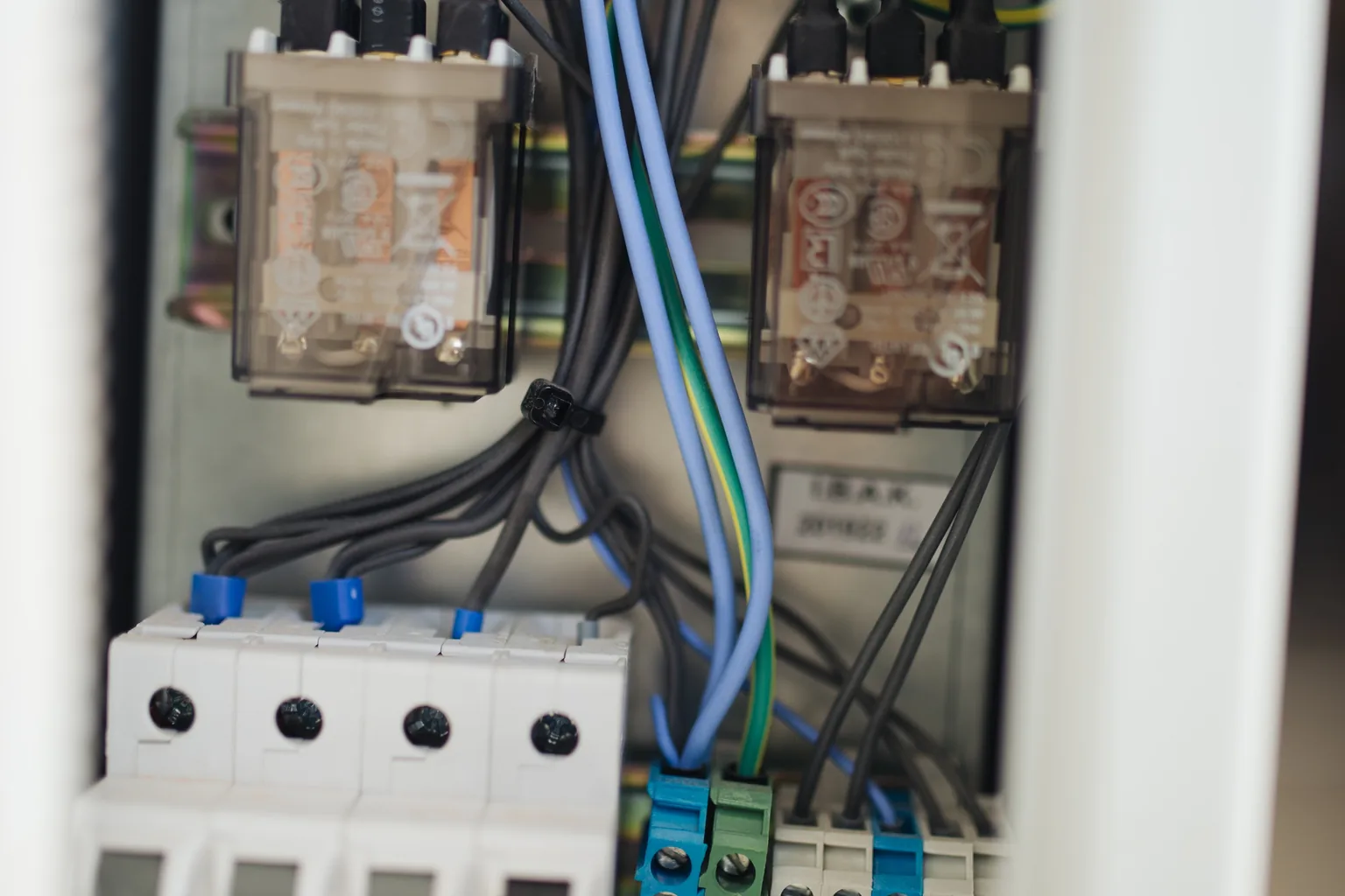 Relays, breakers and terminal blocks inside an open consumer unit