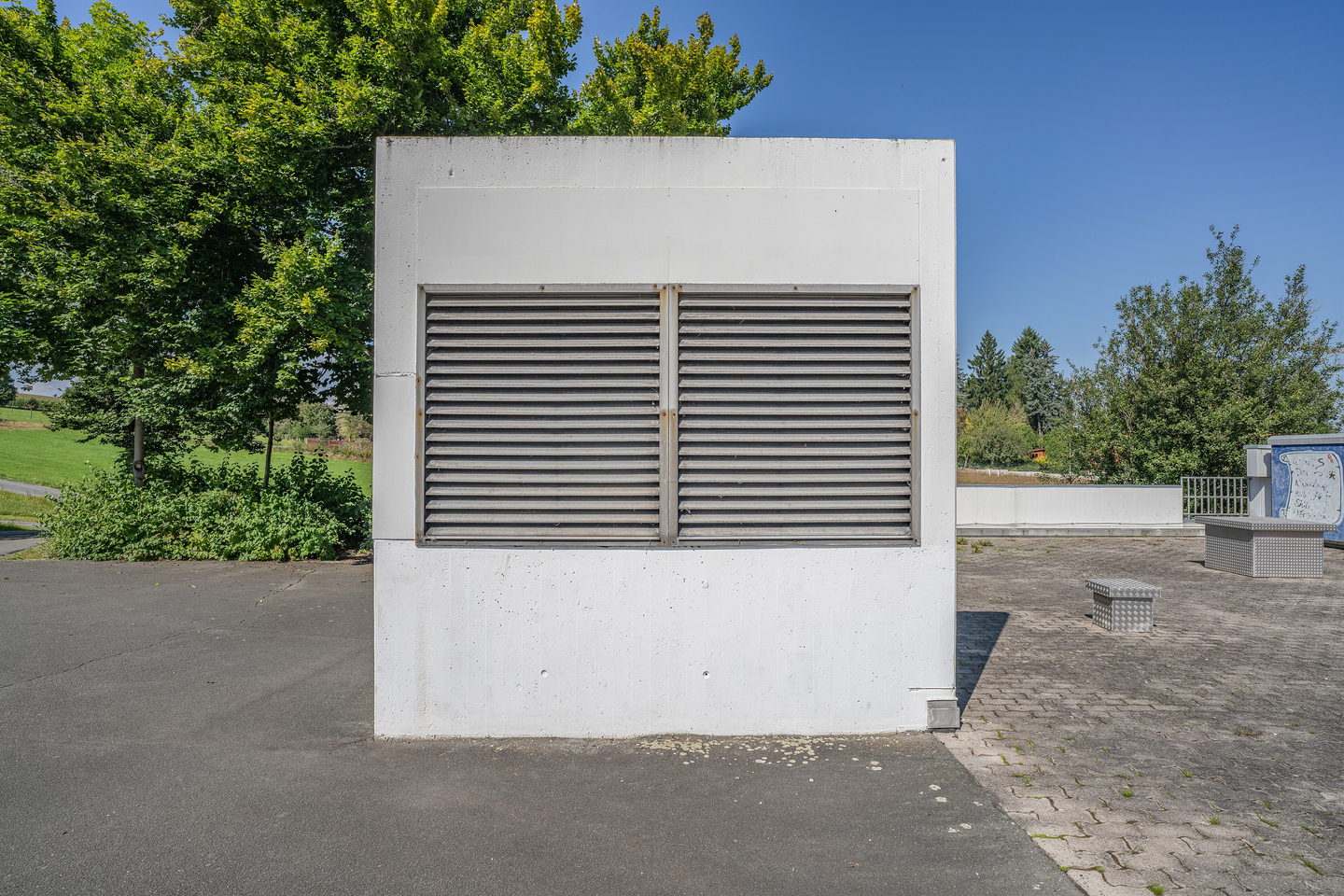 A ventilation plant installation in a machine room, ducting and access doors arranged along one wall.