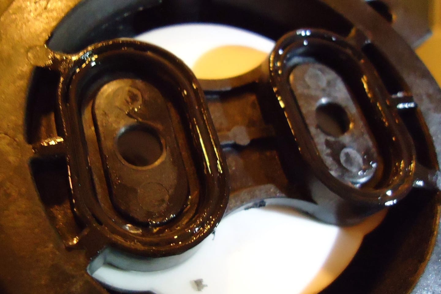 Lubricant being worked onto the seals of a valve cartridge before it is refitted