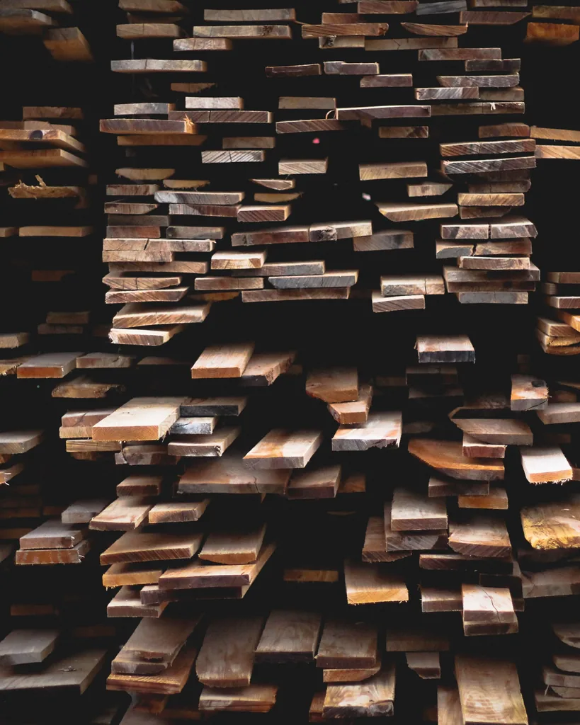Stacked lumber boards seen end-on in a timber store