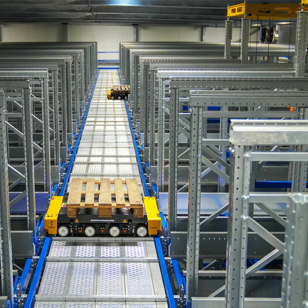 High racking and a central aisle support a retrieval map.