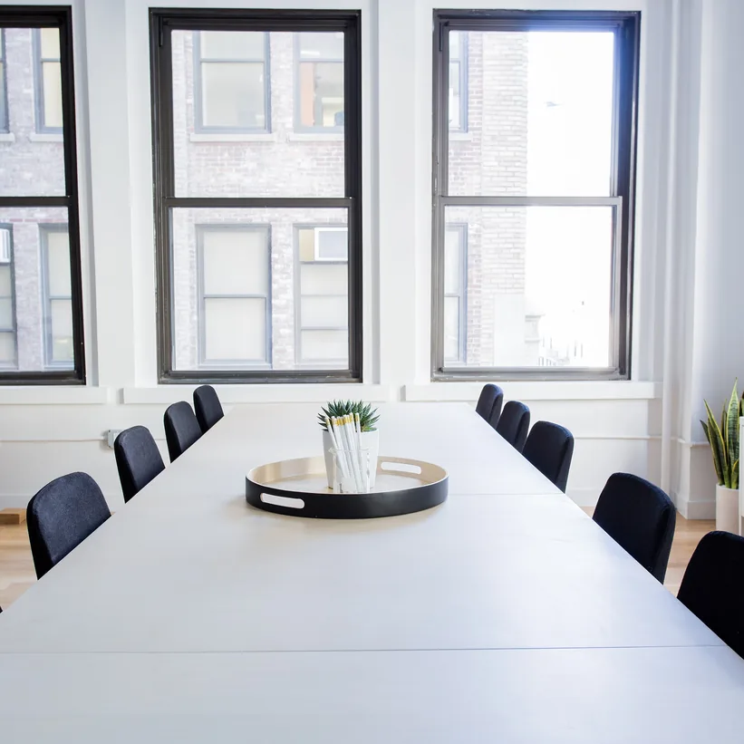 Meeting table and chairs in a light-filled office room