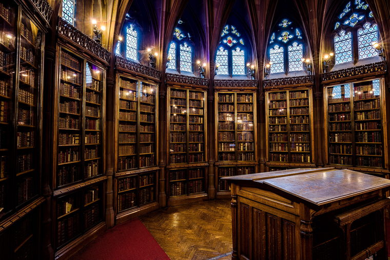 A law library reading room under a vaulted ceiling, with galleries of bound volumes on three sides.
