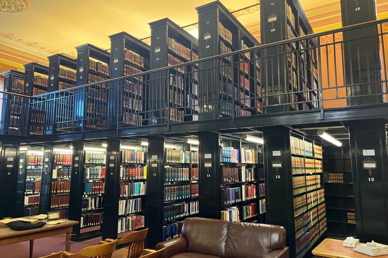Bookcases of legal volumes running the length of a library wall.