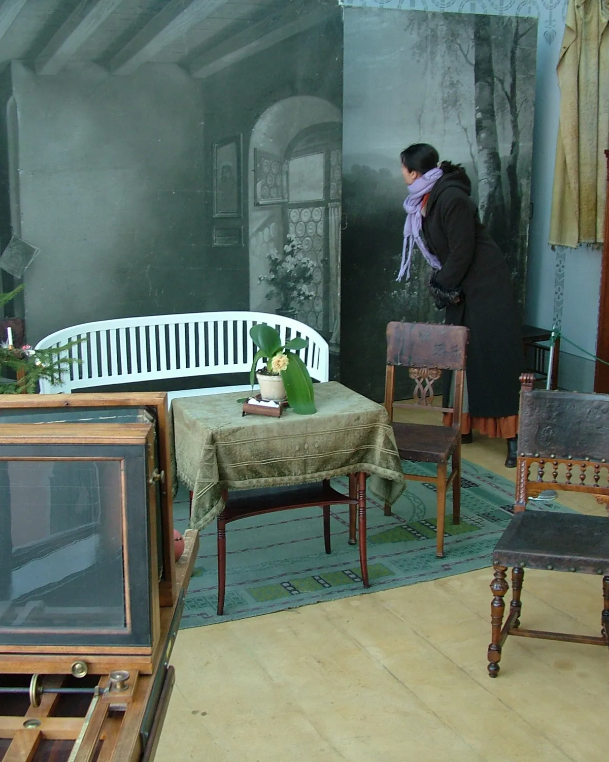 Portrait atelier with a painted backdrop and studio furniture