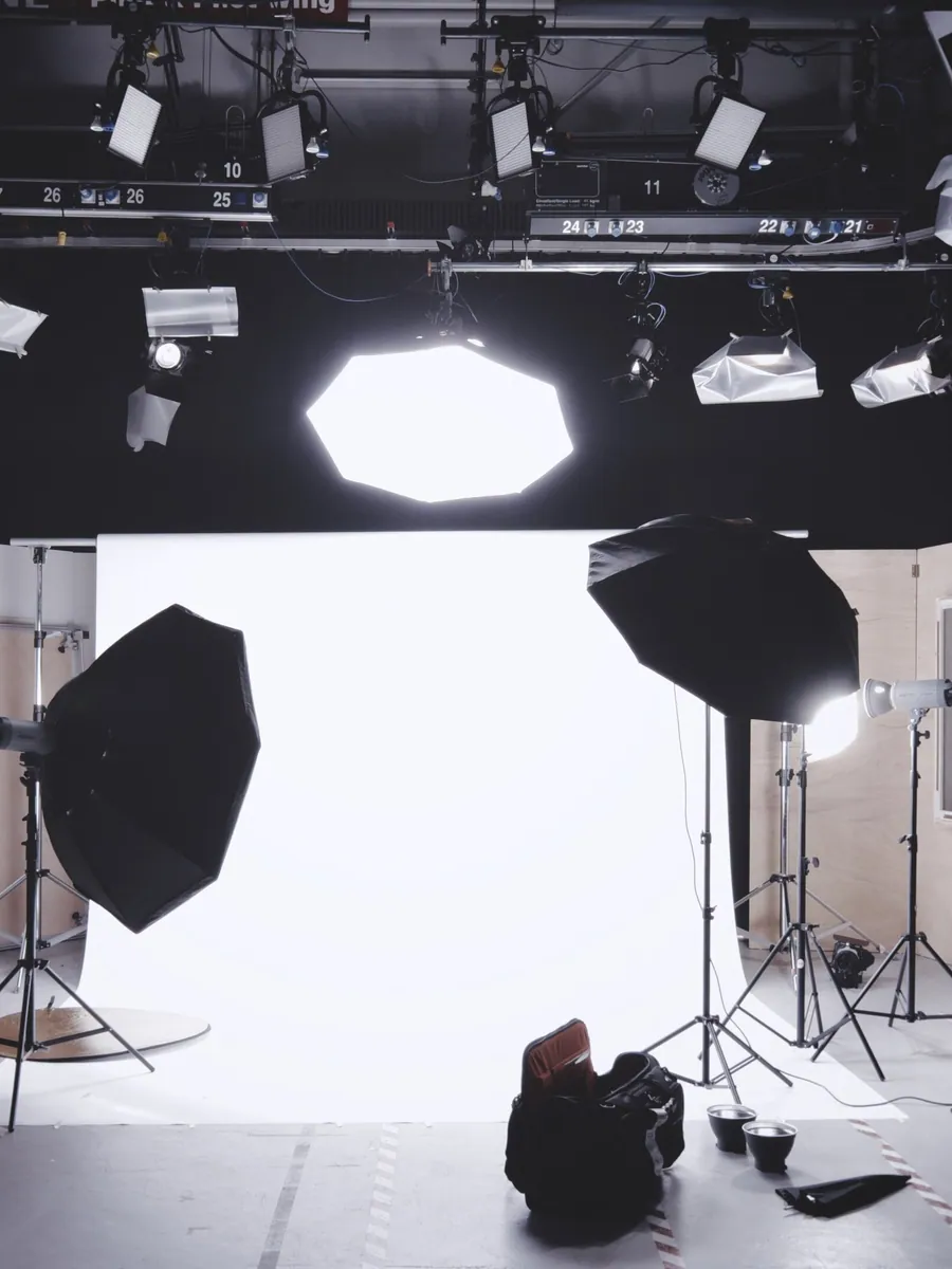 Studio lighting rig and seamless backdrop prepared before a session