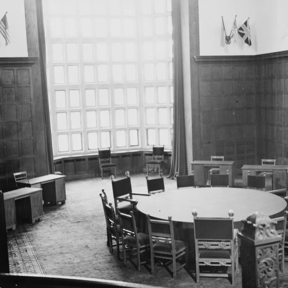 Long review table set with documents and chairs