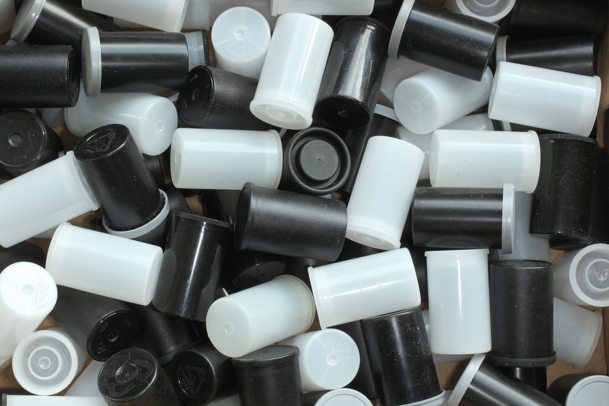 A boxful of empty 35mm film canisters