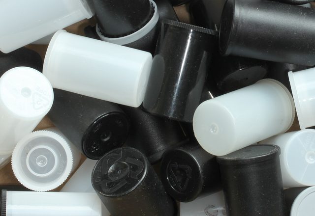 Empty 35mm film canisters in a box