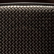 The mesh grille of a microphone, close up.