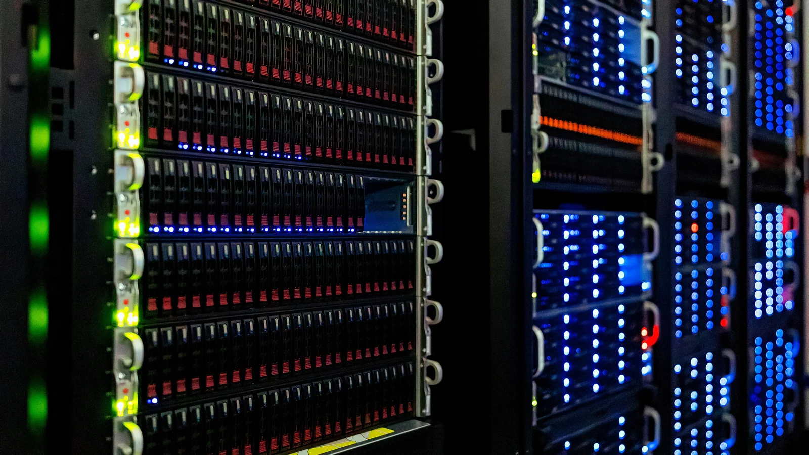 Cyan-lit server equipment in a dark technical workspace