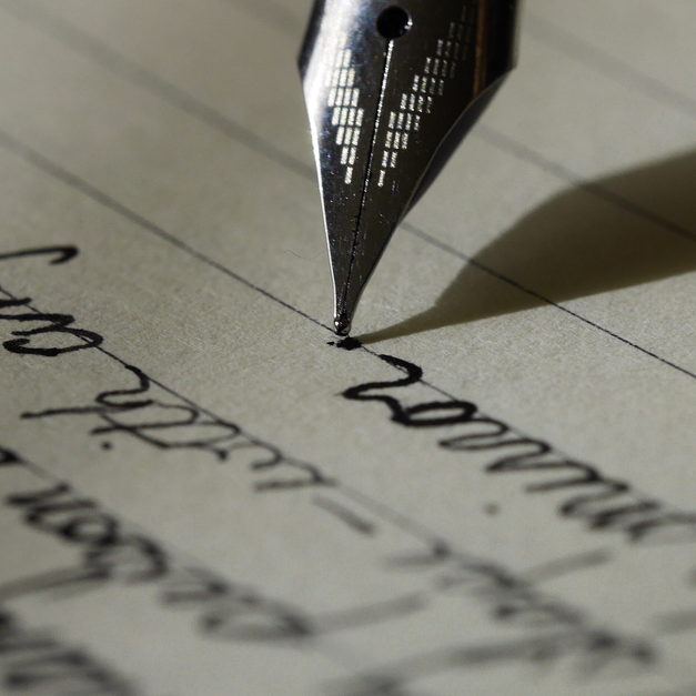 A fountain pen resting on a sheet of handwritten notes.