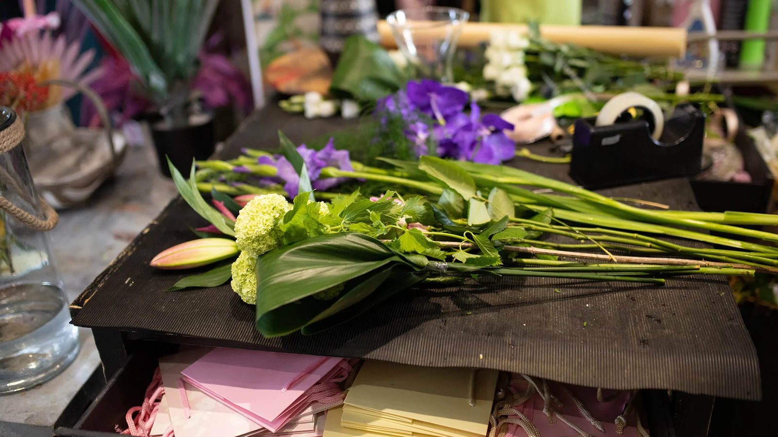Stems laid out on the bench with wrapping paper ready for a bouquet
