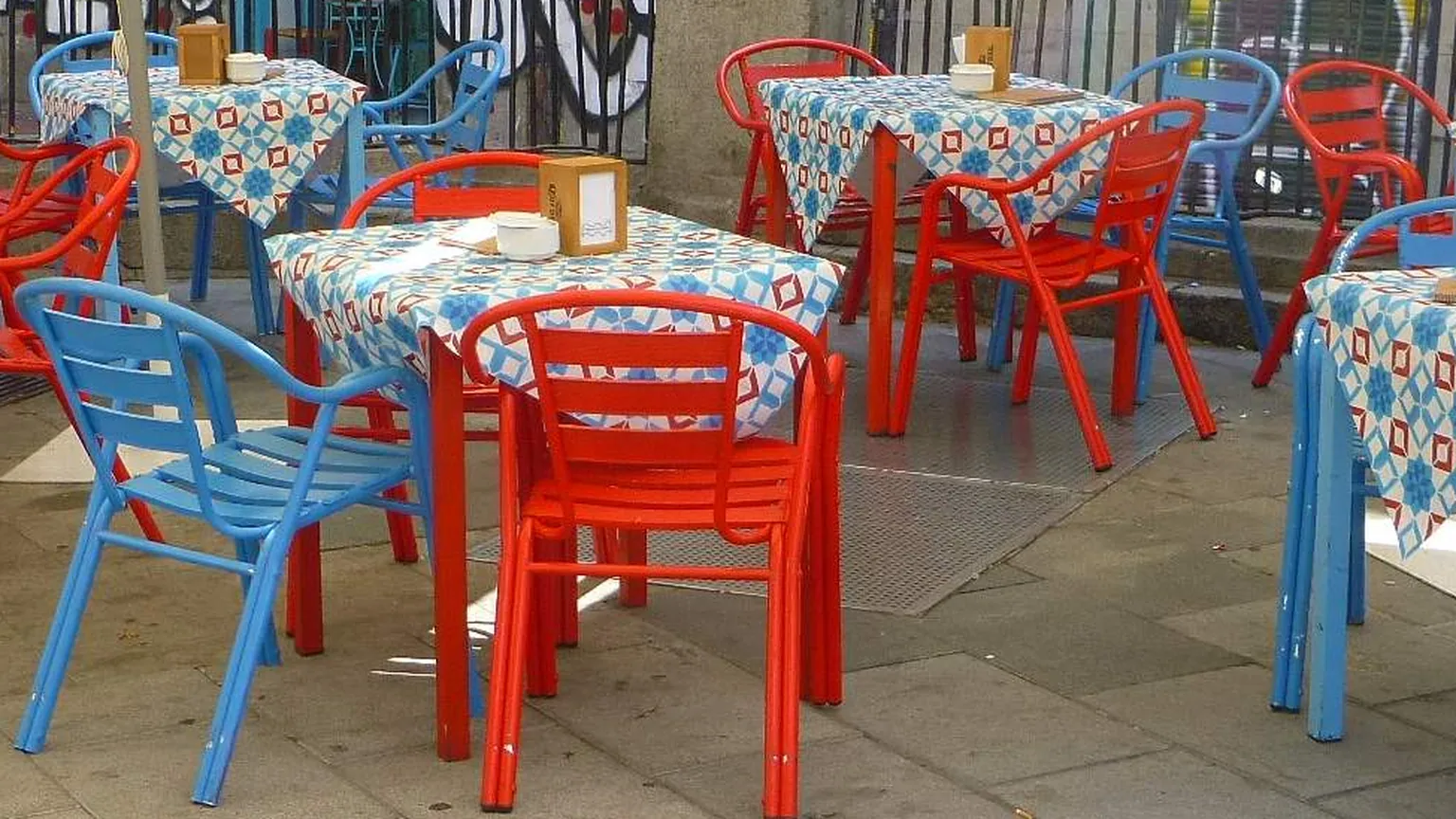 Sunlit café courtyard prepared for morning service